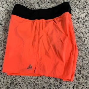 Orange Reebok athletic shorts